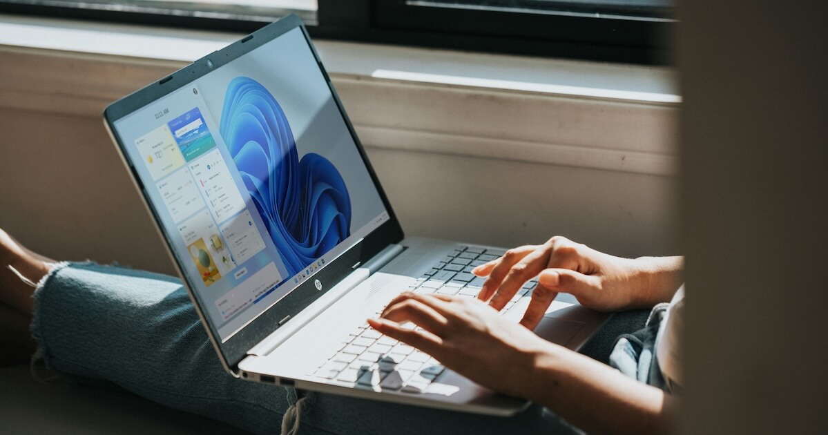 Person using a laptop running Windows 11, setting up a bootable USB on macOS